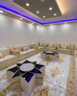 Luxurious beige and gold Arabic Majlis by Diwanzane, featuring elegant seating, a detailed rug, and ambient lighting for an upscale living room.