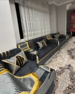 Opulent black and gold Arabic seating by Diwanzane, with plush cushions and an intricate rug design that elevates the room’s luxurious feel.