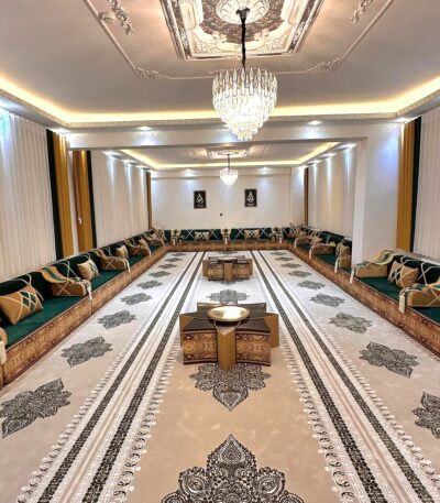 Modern Diwanzane Majlis with rich green and gold tones, featuring elegant cushions and a refined rug design for a regal and welcoming atmosphere in USA.