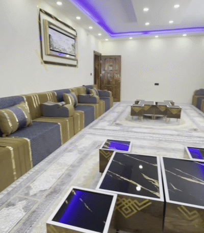Yemeni Majlis seating with luxurious gold and blue accents, featuring comfortable cushions and elegant coffee tables by Diwanzane.