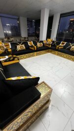 Modern Arabic majlis featuring Yemeni wooden seating with premium velvet cushions and ornate gold details