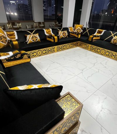 Modern Arabic majlis featuring Yemeni wooden seating with premium velvet cushions and ornate gold details