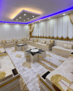 Modern Arabic Majlis by Diwanzane, with soft beige upholstery and gold accents, paired with a sophisticated rug and contemporary lighting for a chic atmosphere.